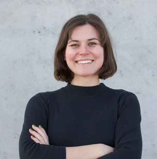 Smiling girl with brown hair and a black shirt